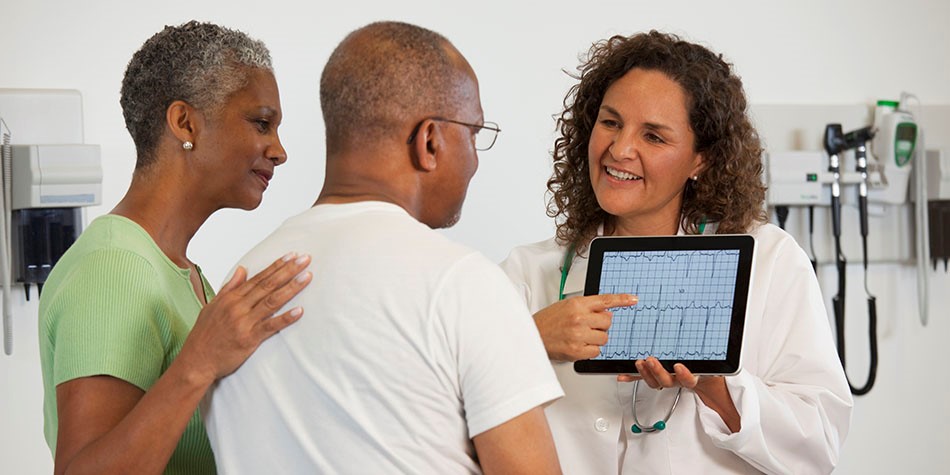 Doctor explaining chart to patient and family member