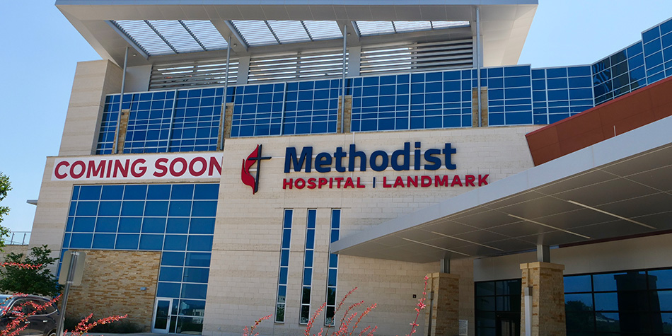 The exterior of a new hospital with signs that read: Coming Soon: Methodist Hospital Landmark.