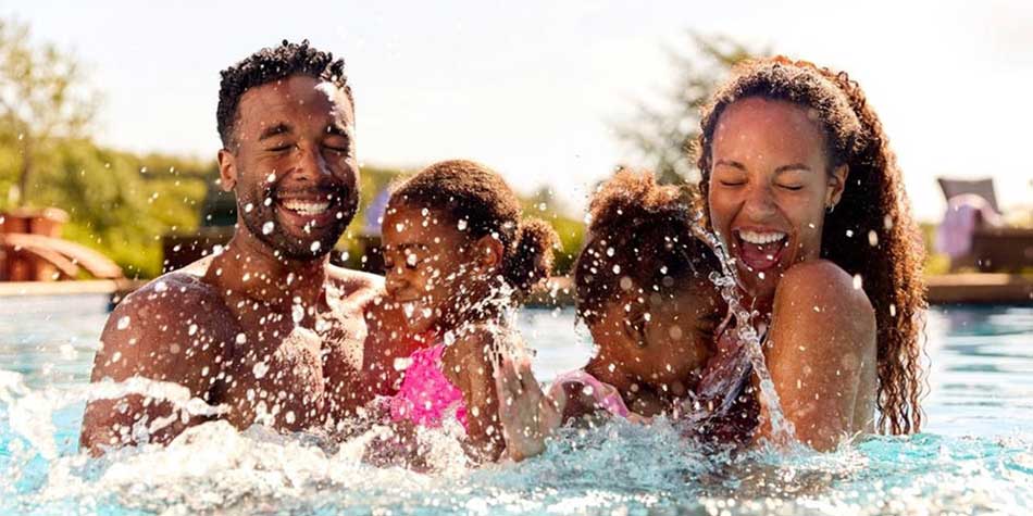A family splashes in a pool.