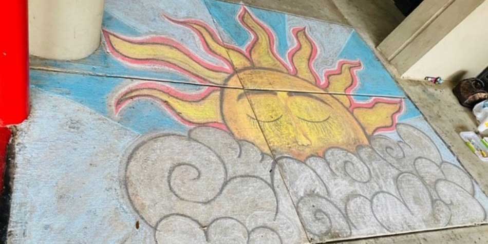 chalk drawing on sidewalk of the sun
