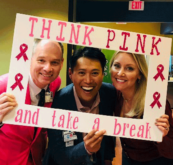 people holding a sign that says think pink and take a break