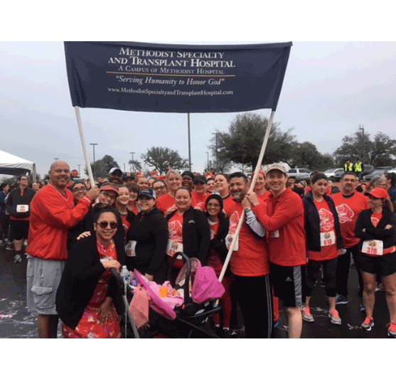 fundraisers carrying a Medthodist Specialty and Transplant Hospital banner