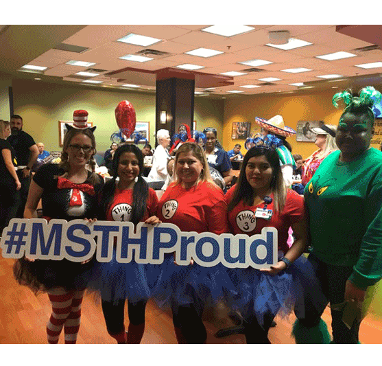 staffers in costumes carrying a #MSTHProud sign