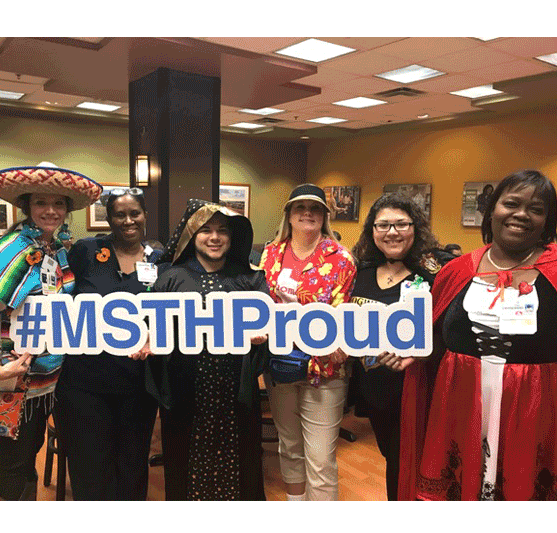 more staffers in costumes carrying a #MSTHProud sign