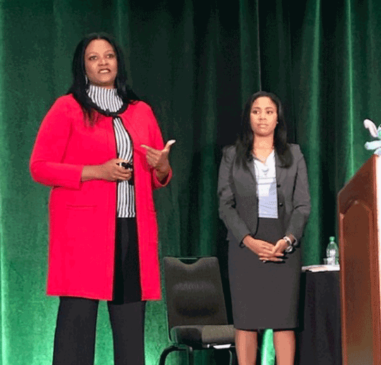two women on stage at the conference