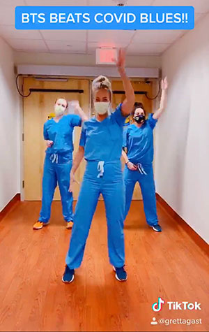 a screenshot of a TikTok with hospital staff dancing and the words BTS Beats COVID Blues!! written at the top